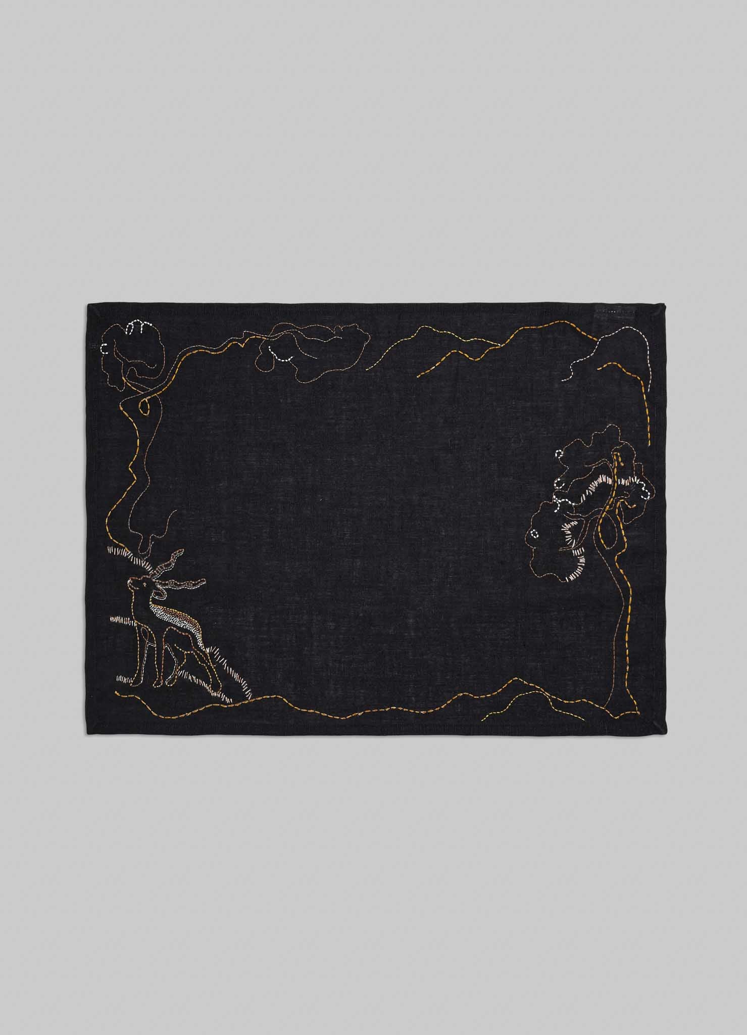Black fabric with embroidered designs on a gray background viya luxury placemats