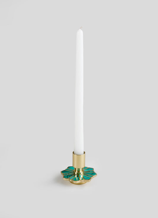 A taper candle holder with a gold metal base and an inlay of green, blue, and teal geometric stained glass pattern, designed for use with a long white candle.