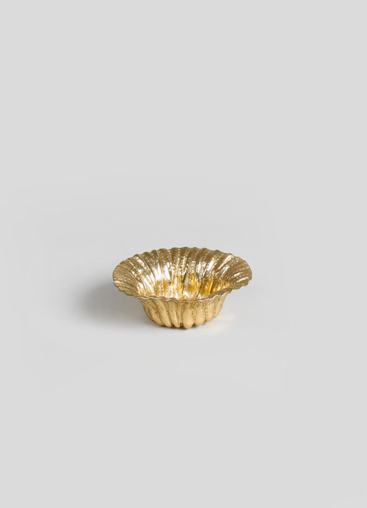 Gold-colored ceramic bowl with a scalloped edge and ribbed texture, featuring a reflective, glossy finish.