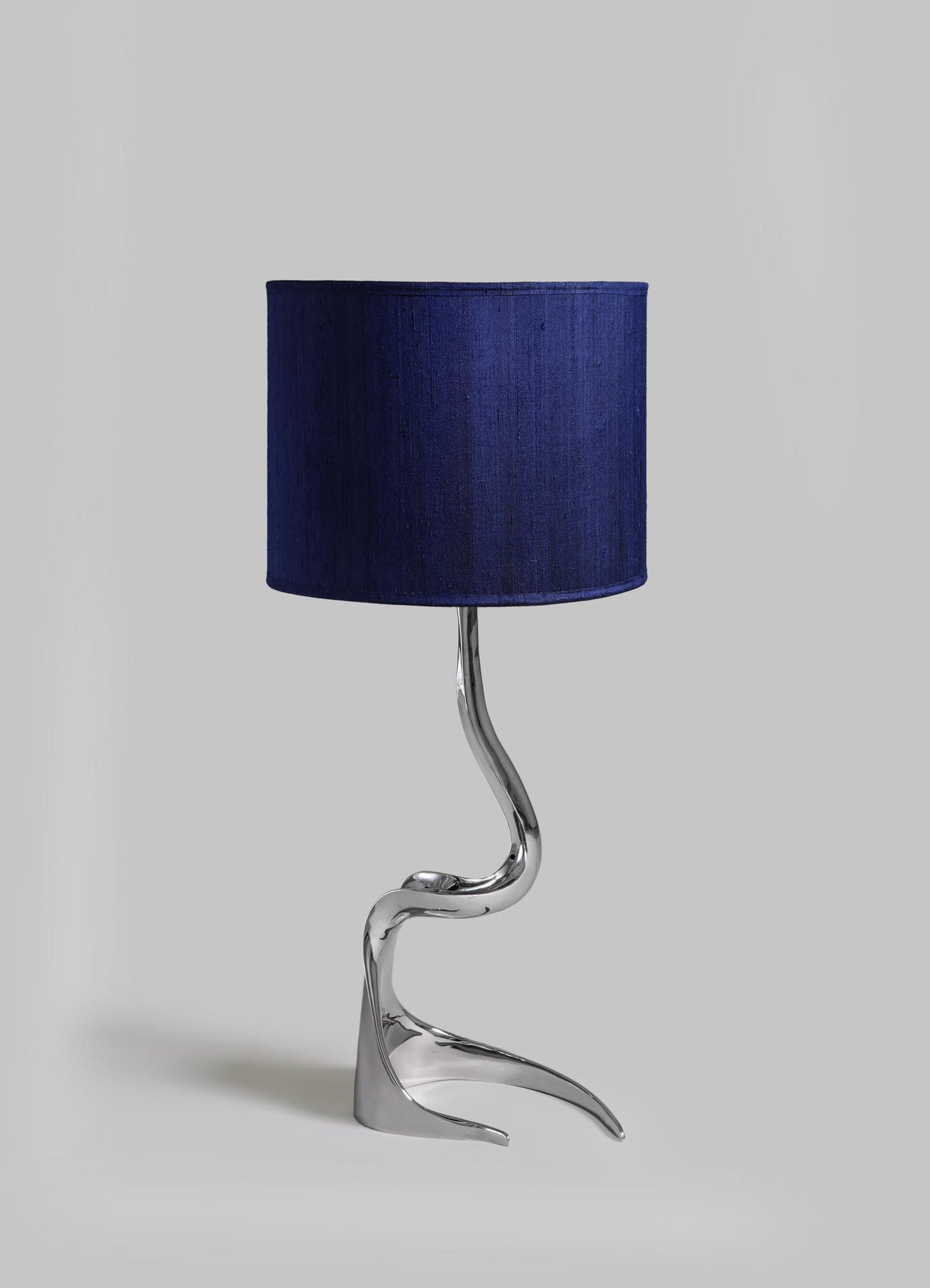 Lamp with a blue shade and silver base on a gray background viya designer luxury table lamp