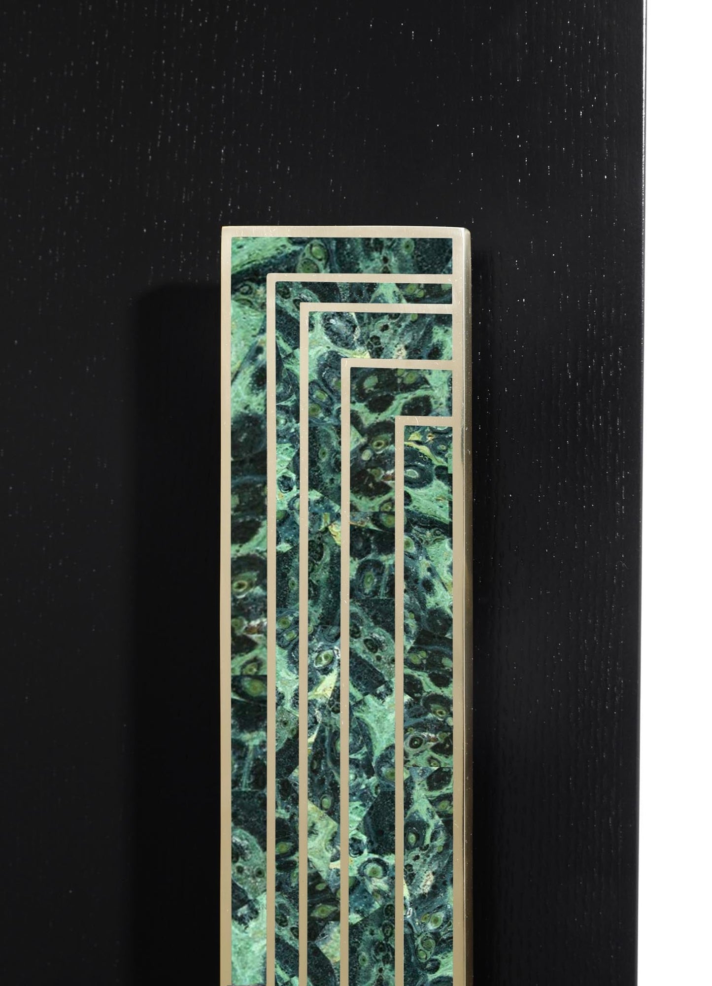 A decorative metal frame with geometric linear patterns surrounds a green marble panel with swirling dark and light tones, set against a black textured background.