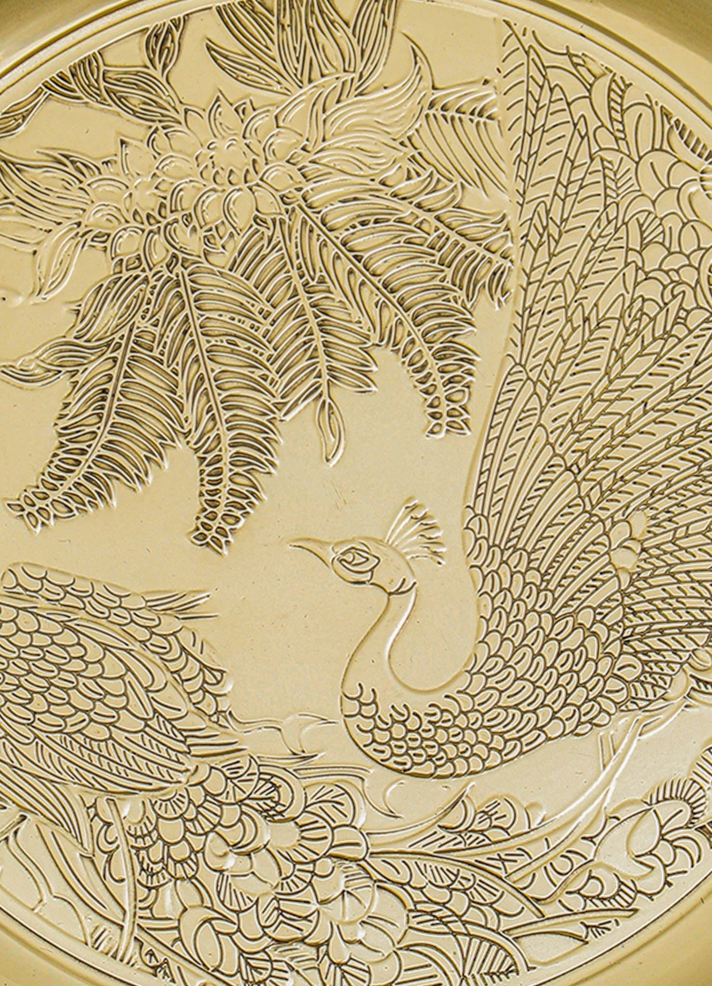 Decorative carved panel featuring a detailed depiction of a peacock among floral and foliage motifs in a carved relief style. The material appears to be wood or similar, with a light, natural finish.