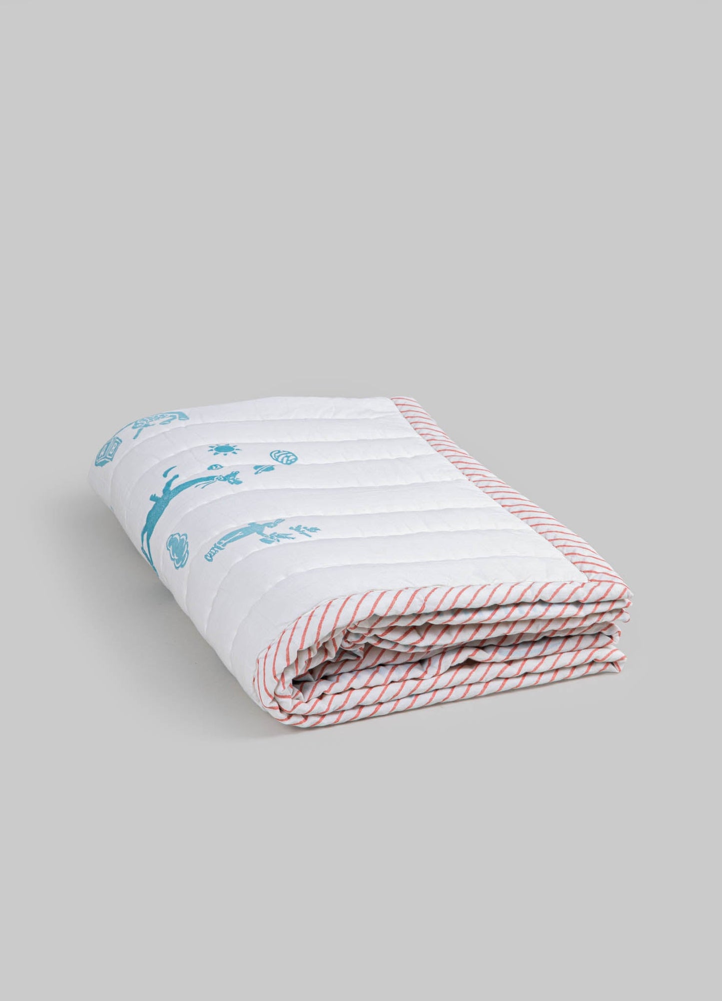 Cotton quilt with a white background, blue printed floral and animal motifs, and red and white striped borders. The quilt has a soft, quilted texture and a contemporary, playful style.