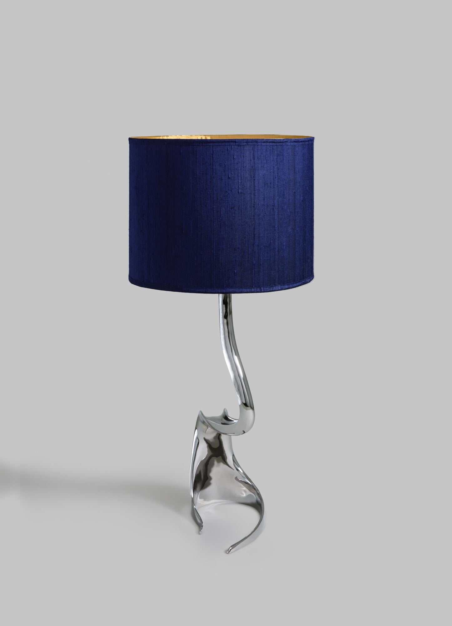 Table lamp with a blue shade and silver base on a gray background viya designer luxury table lamp