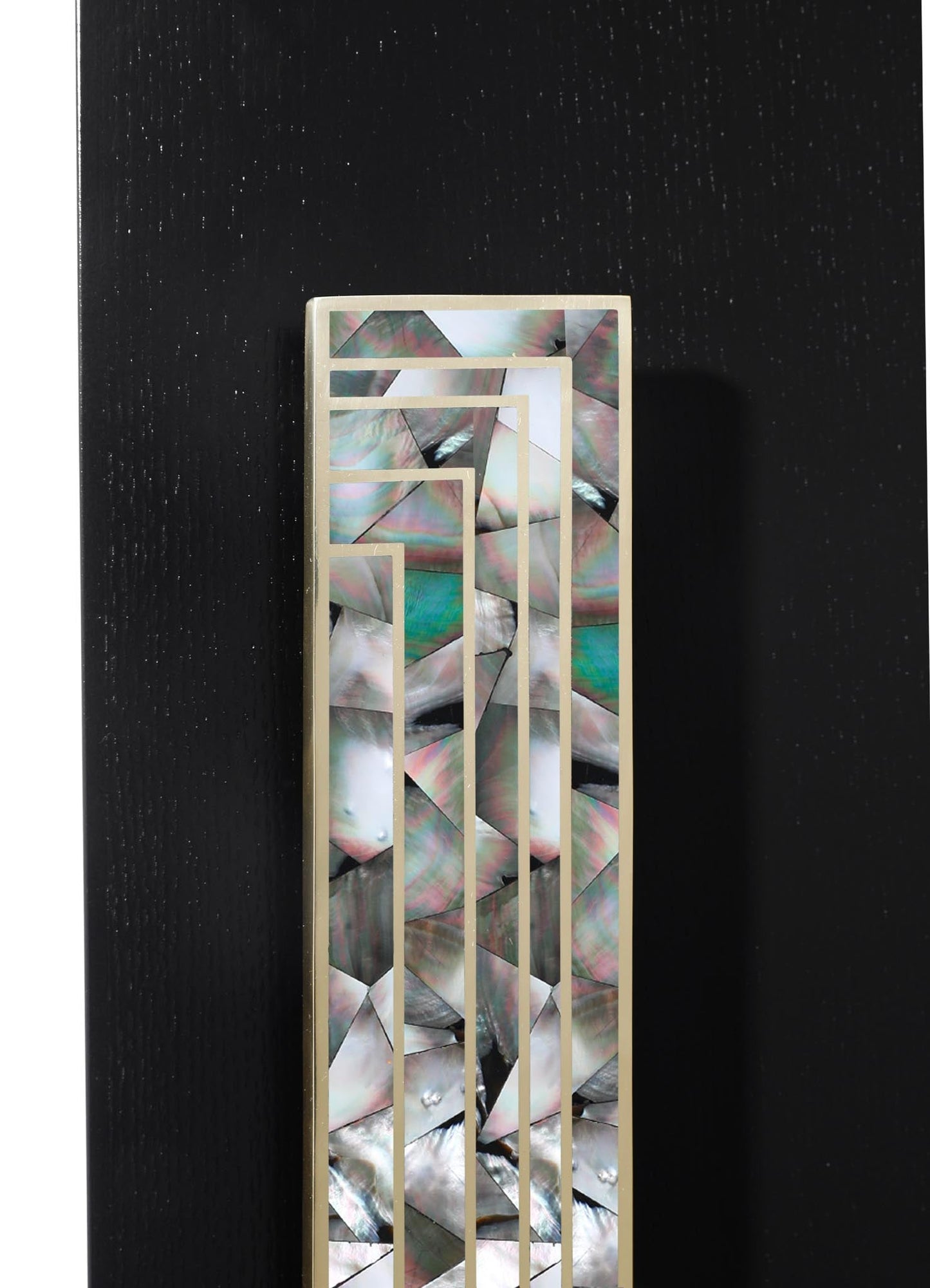 A decorative panel featuring iridescent mother-of-pearl inlay with geometric motifs, framed in a light-colored material, set against a black background.