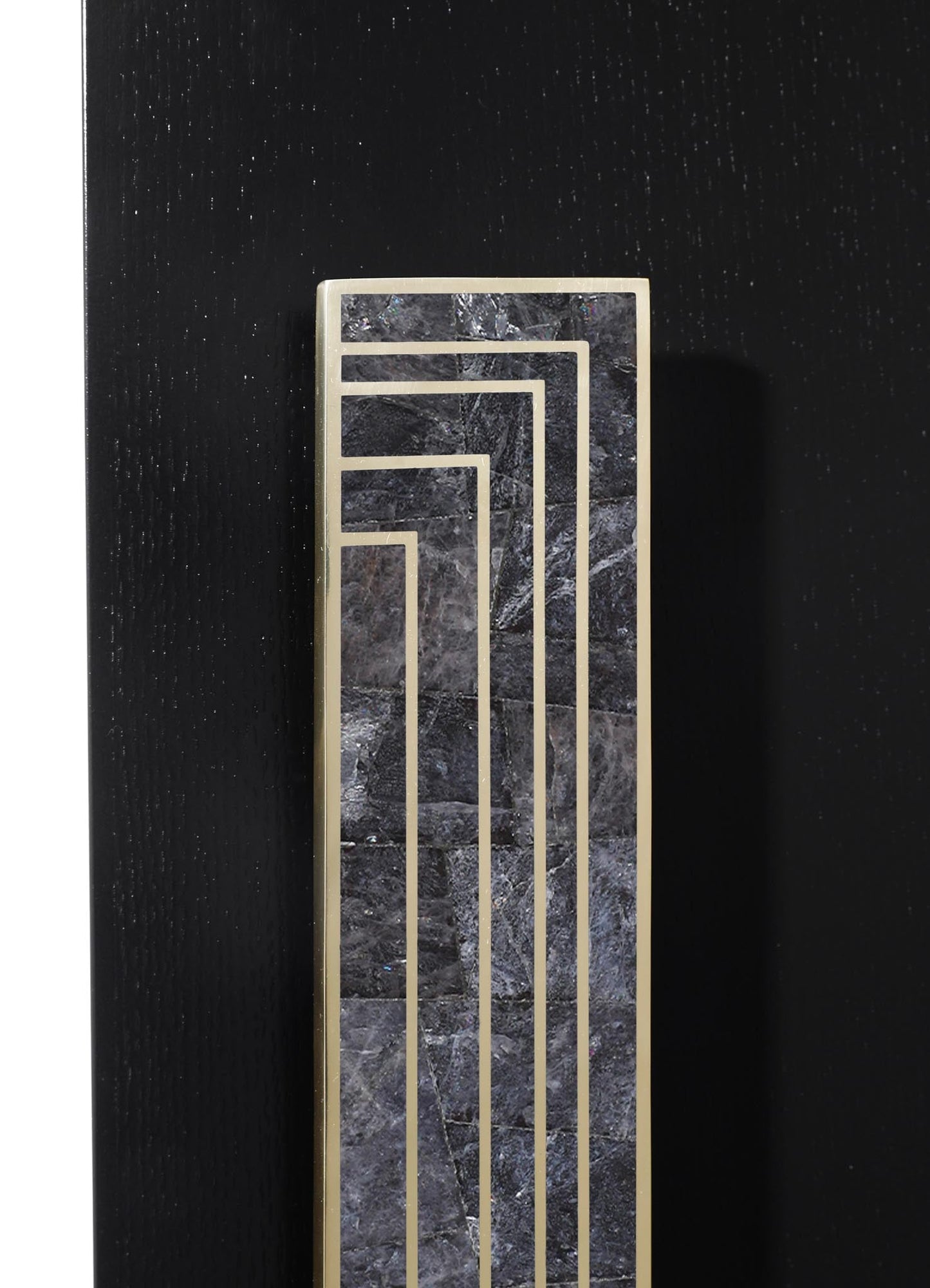 A decorative vent with a rectangular shape featuring a dark marble surface with gray veining, framed by metallic gold lines arranged in a geometric pattern, mounted on a black textured wall.