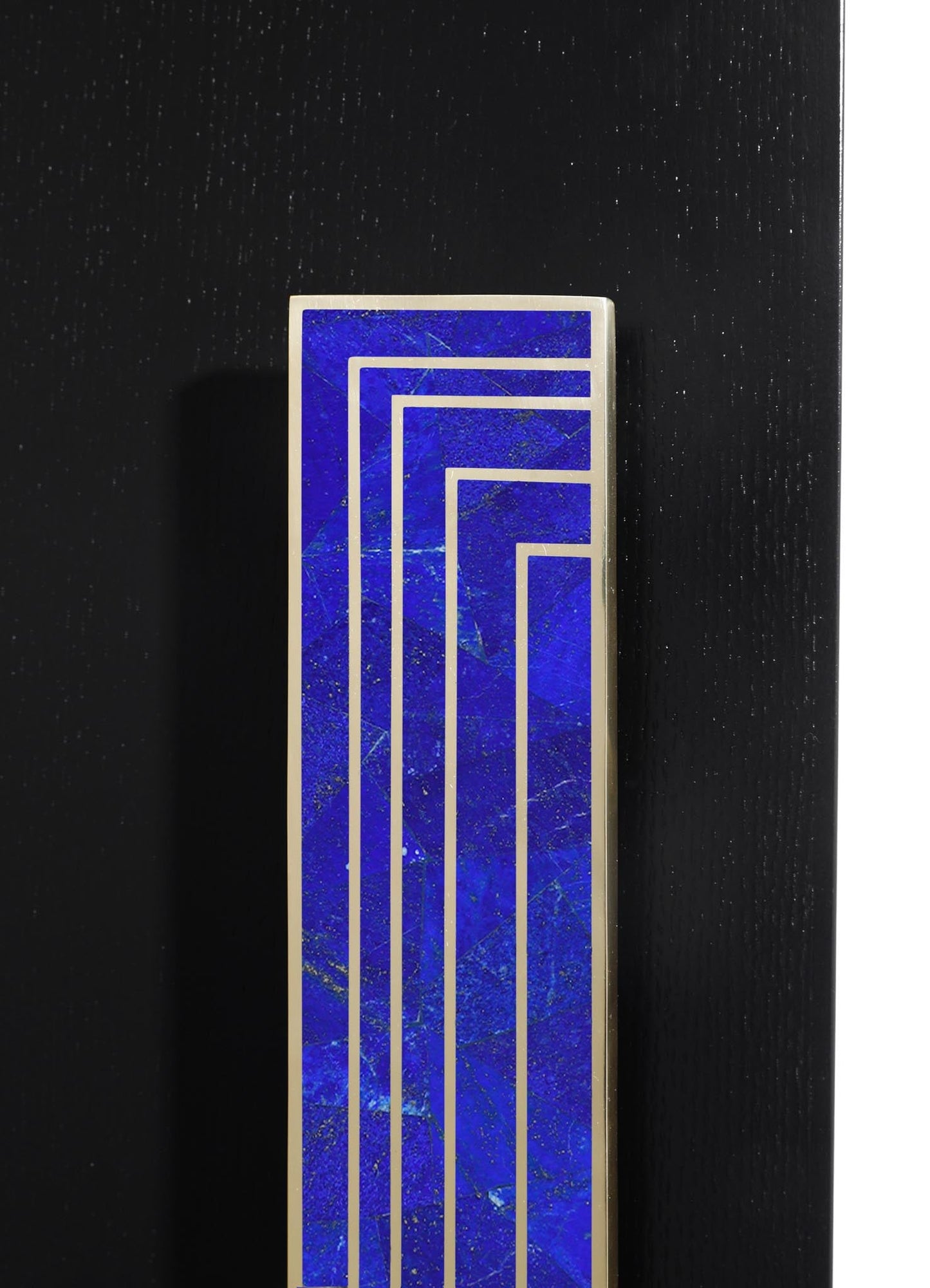 A rectangular decorative object with a blue marble-like surface and silver geometric lines, set against a black textured background.
