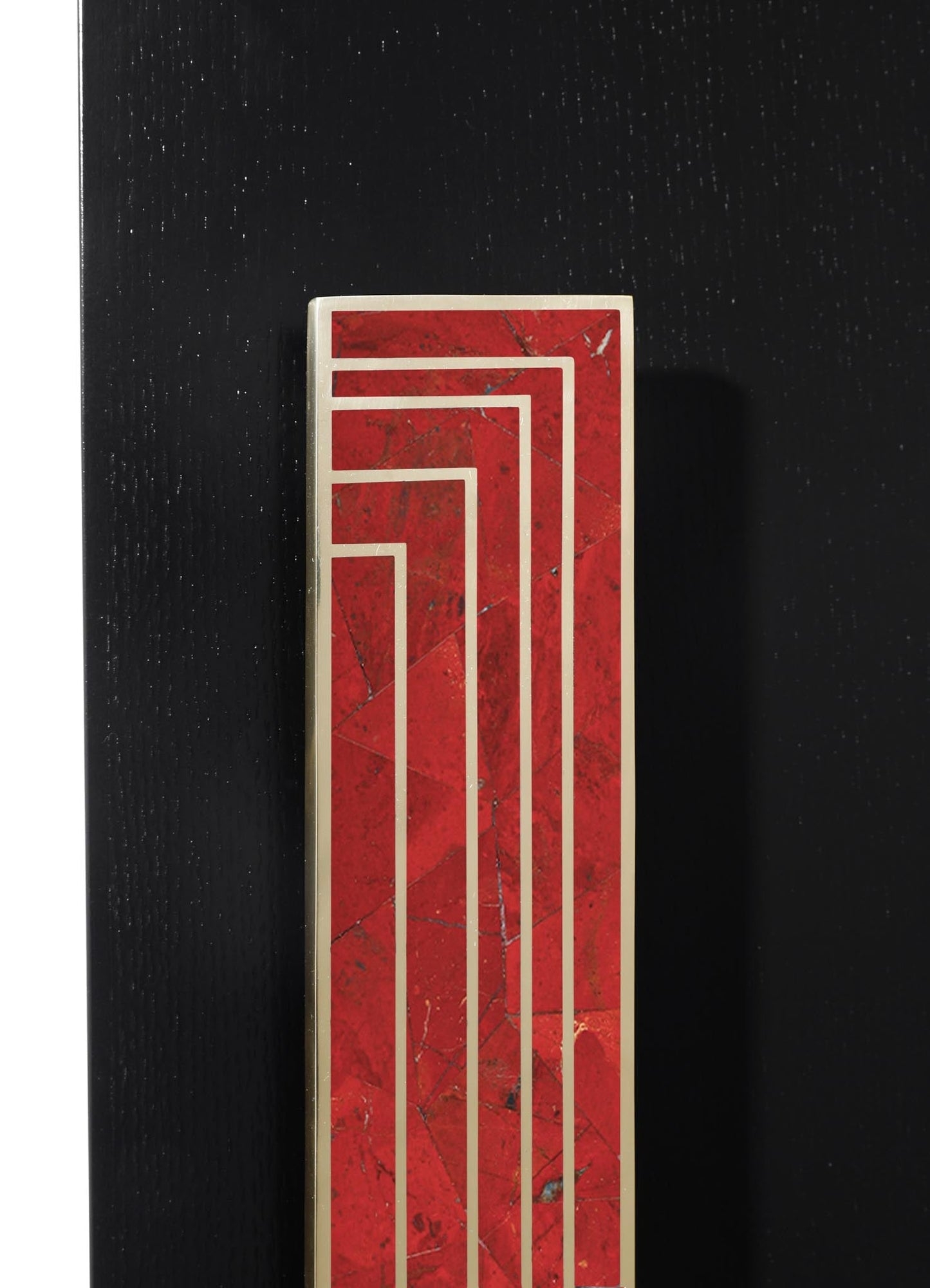 A tall rectangular marble sculpture with red and black veining, featuring geometric gold lines creating a layered pattern, set against a black textured background.