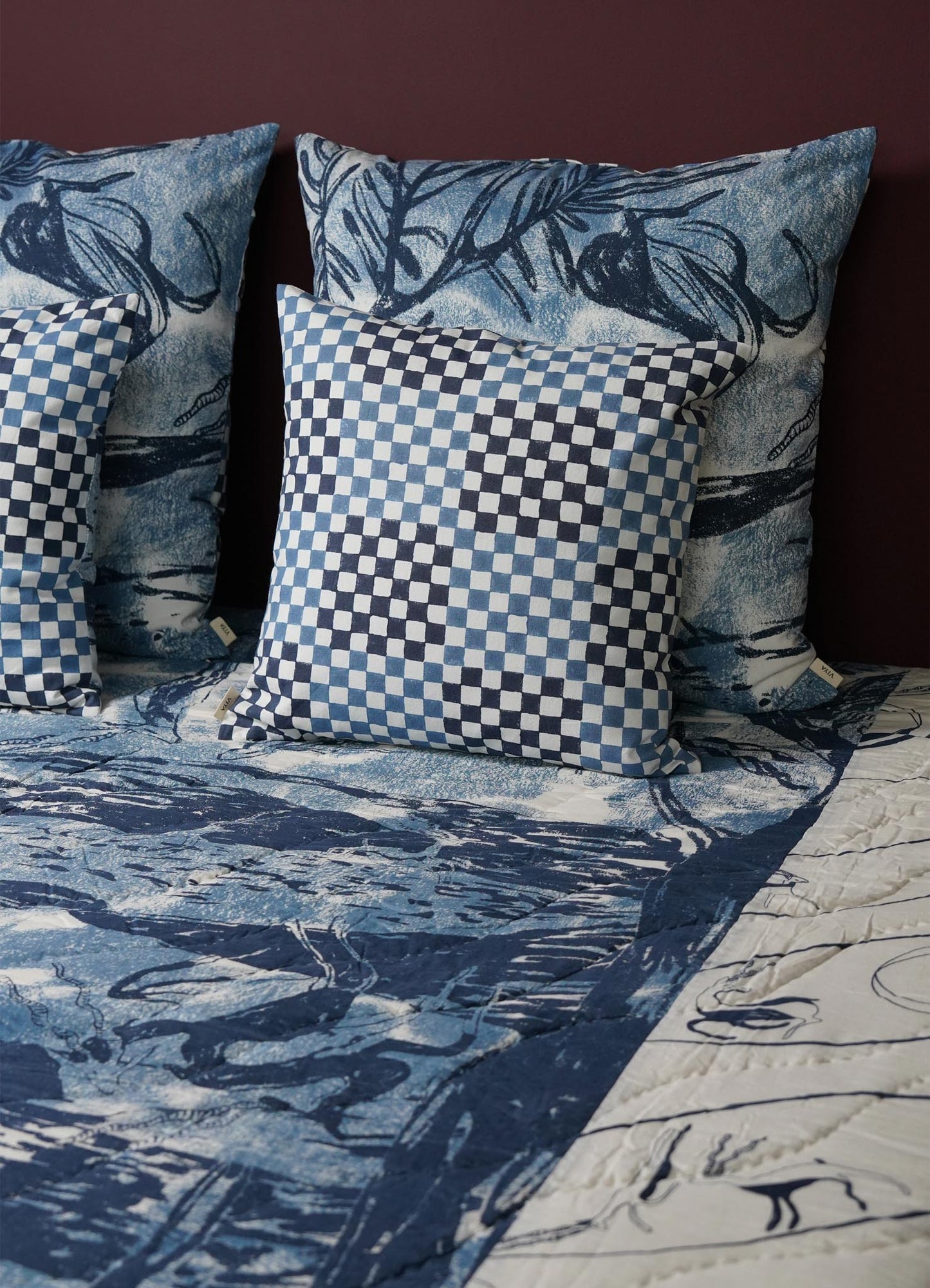 Blue and white checkered pillow cover on a bed with matching bedding viya luxury cushions cushion cover