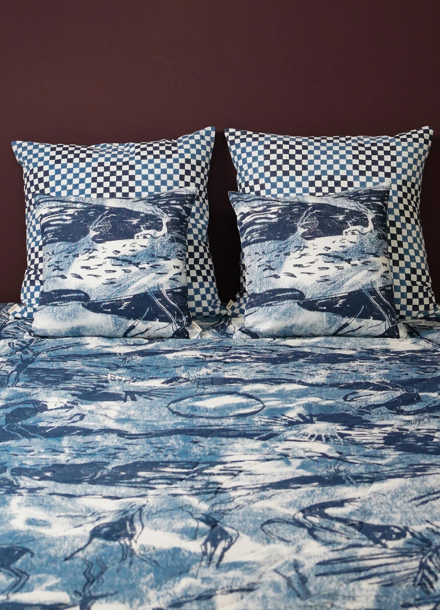 Bedding set with blue and white checkered pillows and matching bedspread. viya luxury cotton quilt