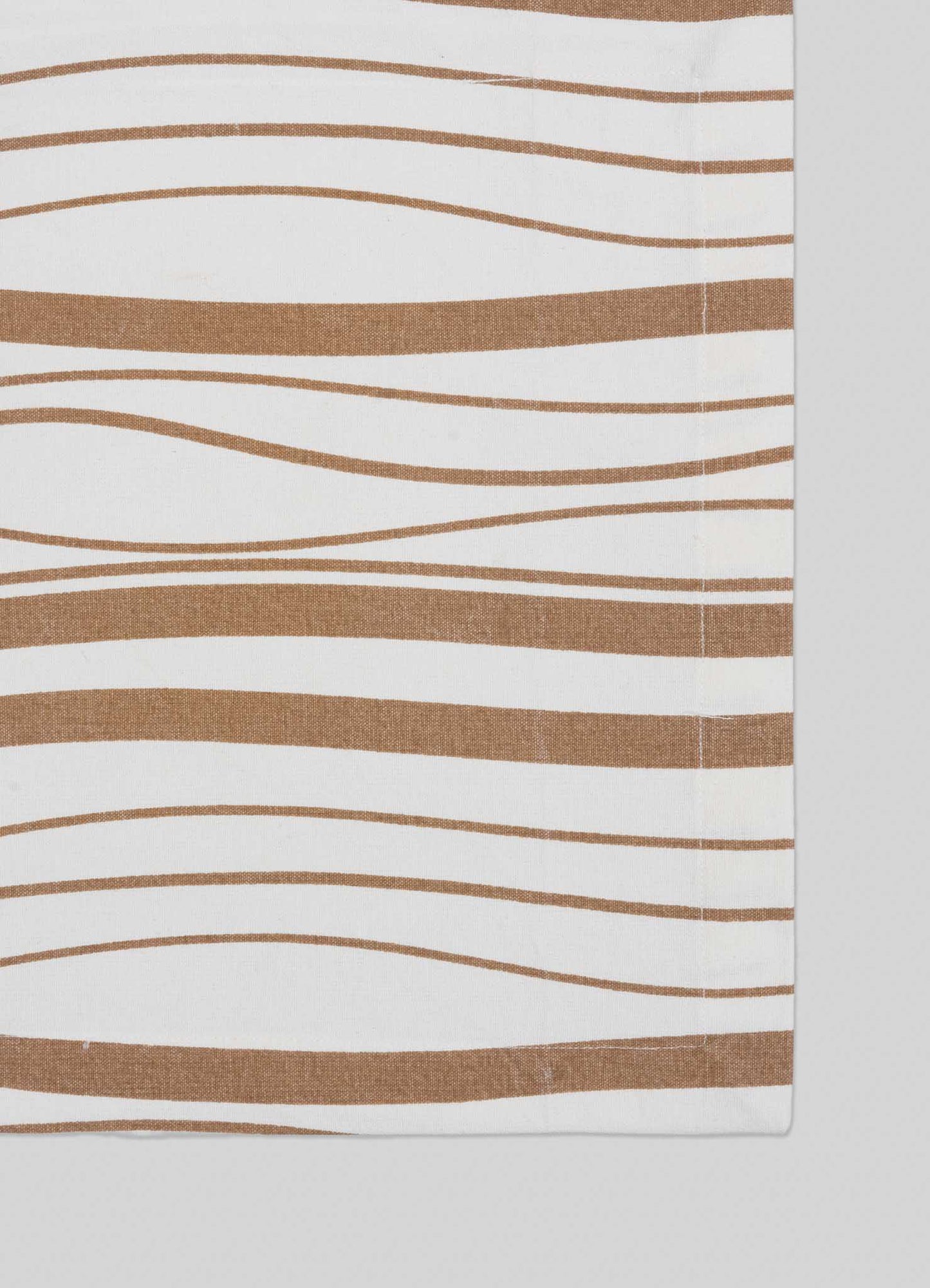The Madras Check Beige Placemats by Viya feature abstract, wavy brown stripes on white fabric, giving a modern edge to Indian textiles. Set of 4 placemats; photo shows the right edge, indicating partial view or fold.