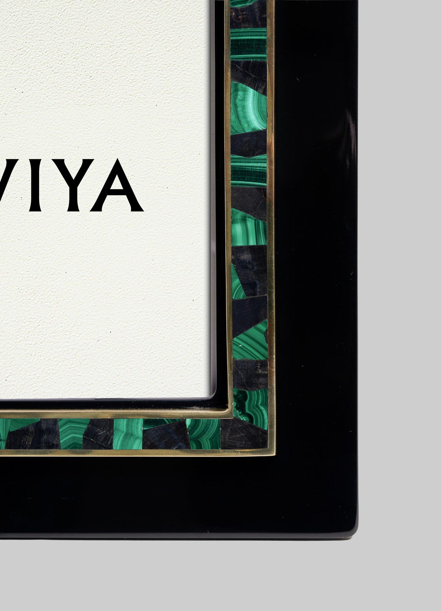 Close-up of the Rivoli Photo Frame by VIYA, featuring a black and green Art Deco border inspired by old Bombay cinema halls. Part of the VIYA logo appears on a white background inside the frame.