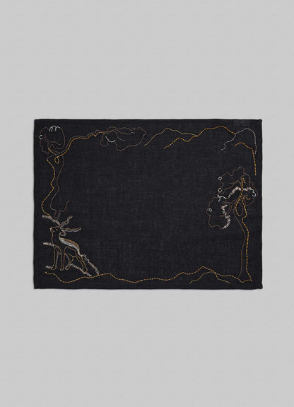Black fabric with embroidered designs on a gray background viya luxury placemats