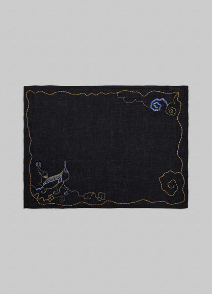 Embroidered black fabric patch with decorative elements on a gray background viya luxury placemats