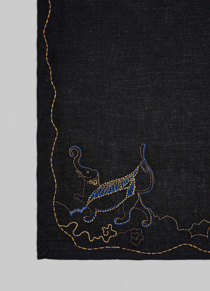 Embroidered design on a black fabric with blue and gold elements viya luxury placemats