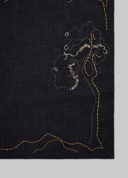 Black fabric with gold embroidery of floral patterns on a gray background viya luxury placemats