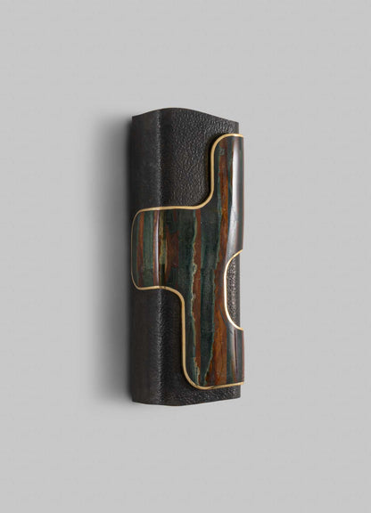 Decorative wall sconce with a cylindrical black textured metal base and multicolored onyx or marble inlay, accentuated by gold-tone trim, in a contemporary style.