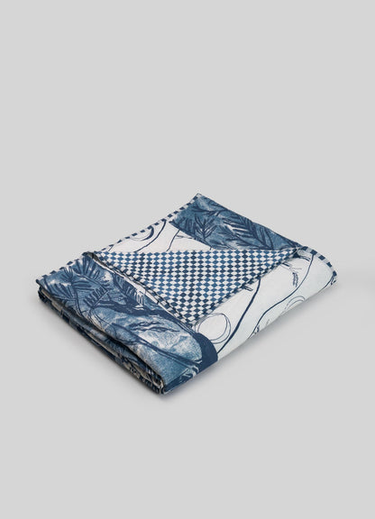 Folded fabric with blue and white patterns on a gray background luxury cotton quilts viya