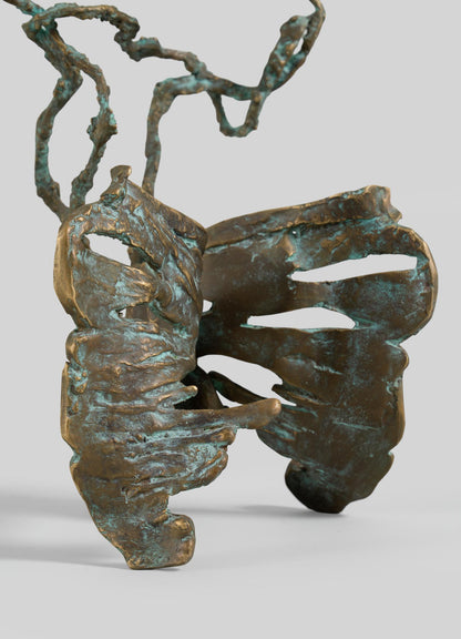 The VIYA Butterfly Candle Stand Medium is a bronze sculpture featuring abstract, wing-like shapes and twisting, branch-like forms with a textured patina finish.