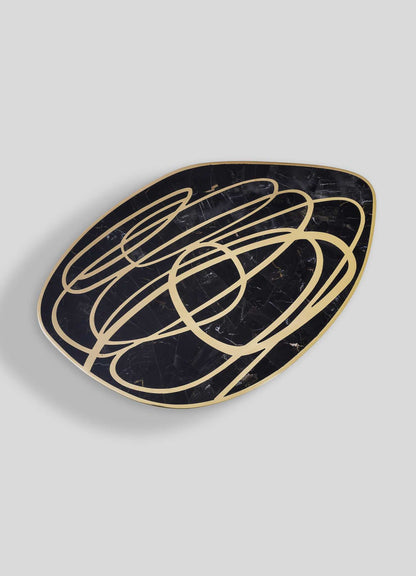Luxury modern side table with black portoro top and gold abstract swirl design, elegant statement furniture for contemporary living room decor.