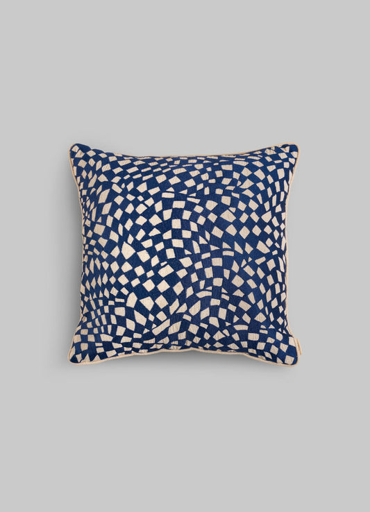 The Viya Dreamscape Blue Embroidered Checks Cushion Cover (18"x18") features an abstract white check pattern on a dark blue background, inspired by textile motifs, shown against a plain light grey backdrop.