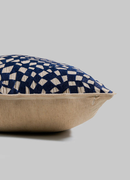 A close-up of the Viya Dreamscape Blue Embroidered Checks Cushion Cover 18"x18", featuring a blue and cream geometric design, visible edge zipper, and set against a plain gray background.