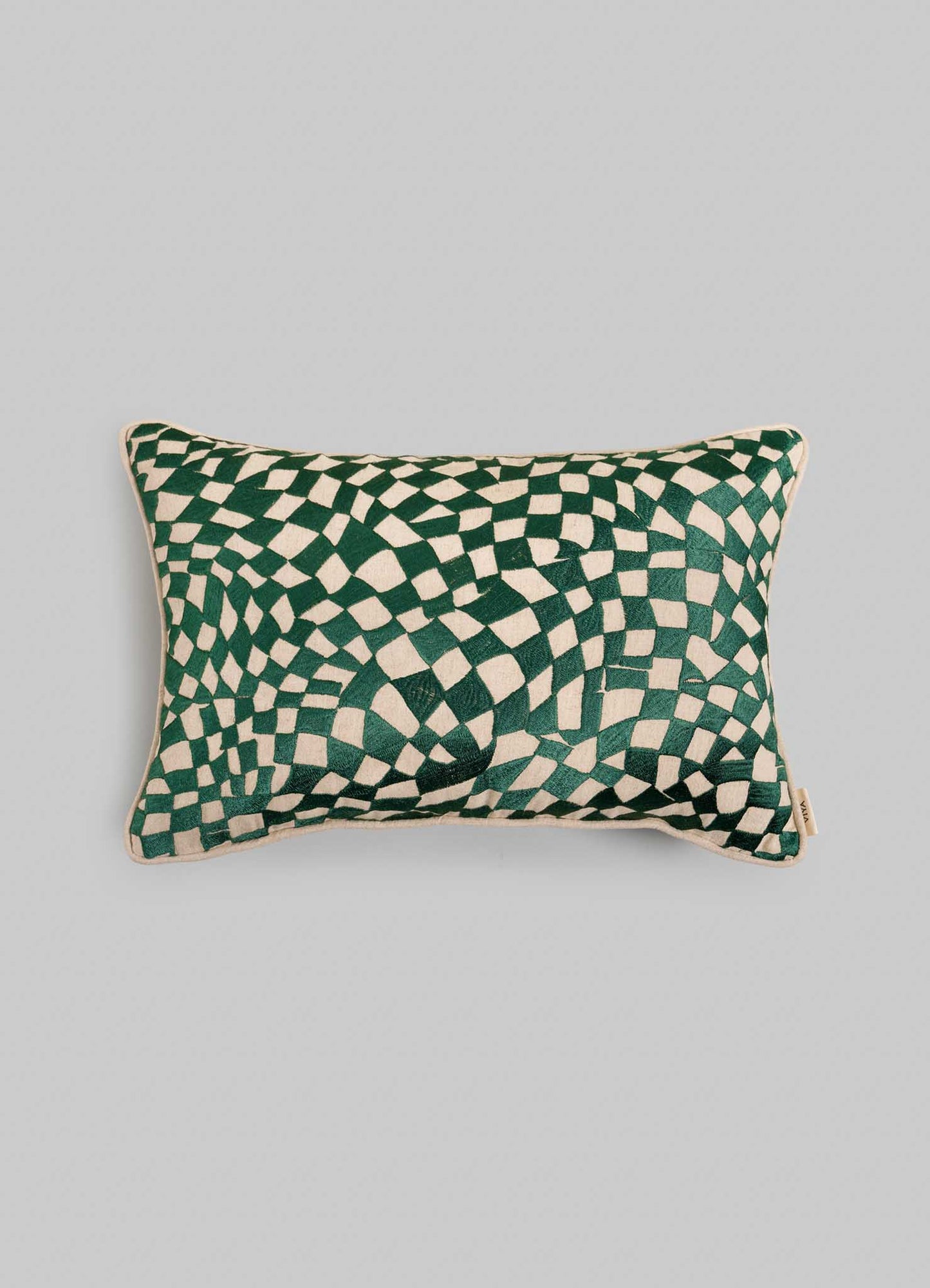The Viya Dreamscape Green Embroidered Checks Cushion Cover (12"x18") features a green and white geometric wavy checkerboard design inspired by embroidered textiles, set on a plain light gray background.