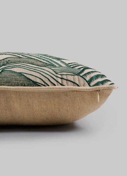 A close-up side view of the Viya Dreamscape Green Embroidered Mounds Cushion Cover 12"x18" shows its beige fabric, visible zipper, and green embroidery, set against a plain gray background.