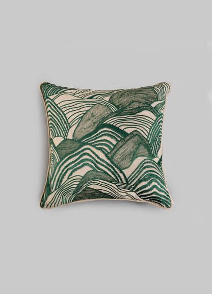 The Viya Dreamscape Green Embroidered Mounds Cushion Cover (18"x18") features a textured, abstract green and cream design reminiscent of Rajput manuscript art, set against a plain light gray background.