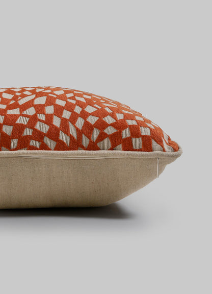 The Viya Dreamscape Orange Embroidered Checks Cushion Cover (12"x18") features a beige base, orange top, and white geometric diamond pattern inspired by embroidered textiles. Shown against a plain light gray background.