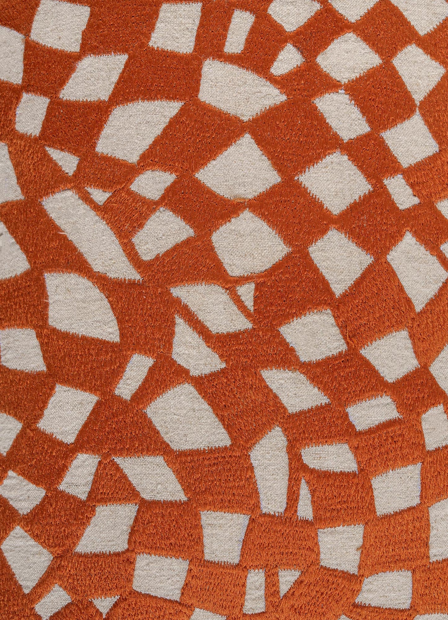 Close-up of Viya’s Dreamscape Orange Embroidered Checks Cushion Cover (12"x18"), featuring an abstract orange and white geometric pattern with a soft, plush texture that evokes intricate embroidered motifs.