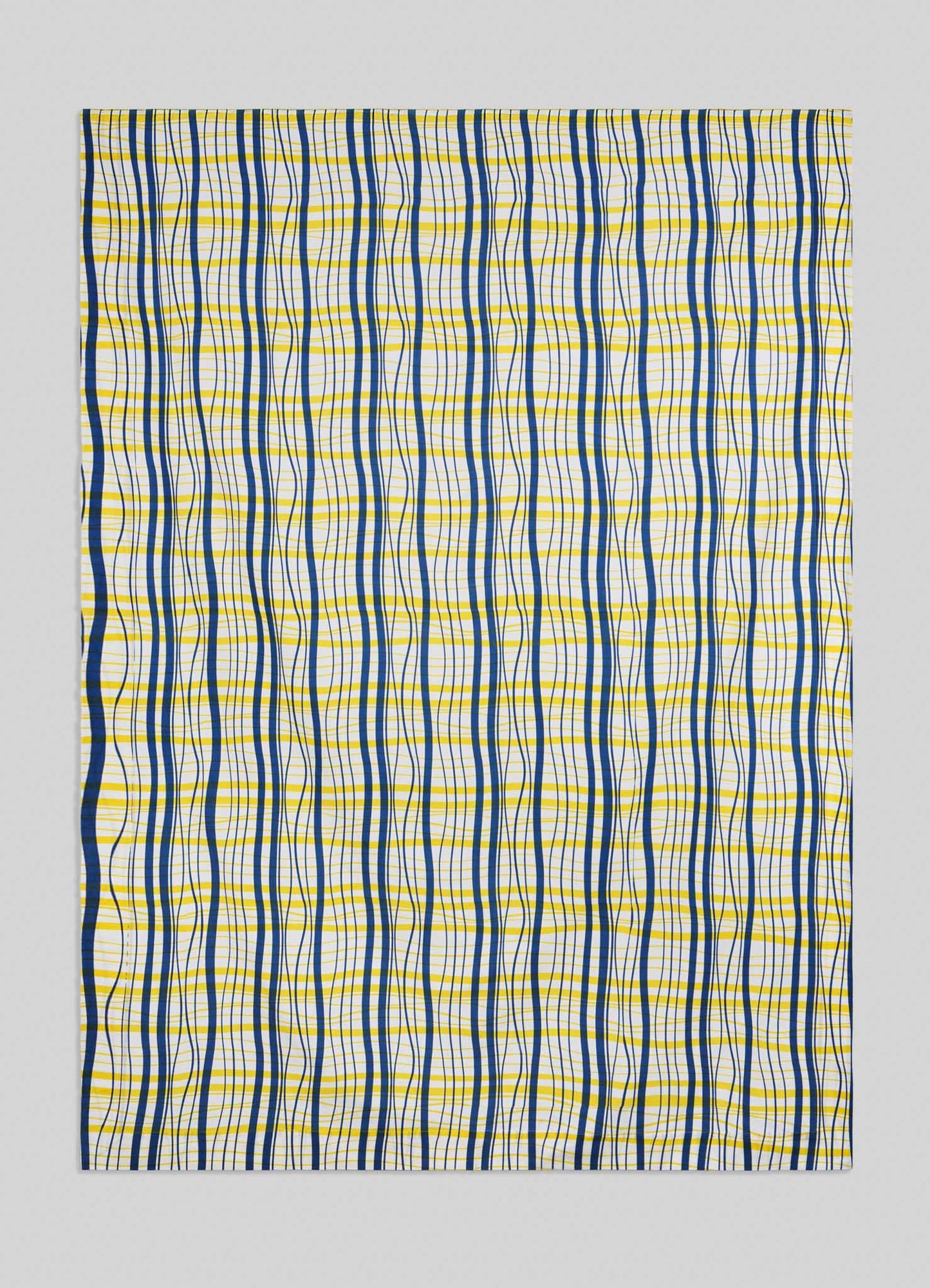 The Viya Madras Check Blue & Yellow Table Cloth features a geometric grid of straight and wavy blue and yellow lines on white, evoking classic Madras checks with an optical illusion twist for a bold, contemporary look.