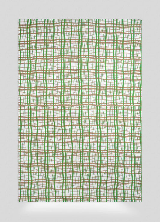The Viya Madras Check Green & Beige Table Cloth features intersecting wavy green, brown, and orange lines on white, forming an abstract grid pattern reminiscent of madras checks with unevenly spaced lines for a modern look.