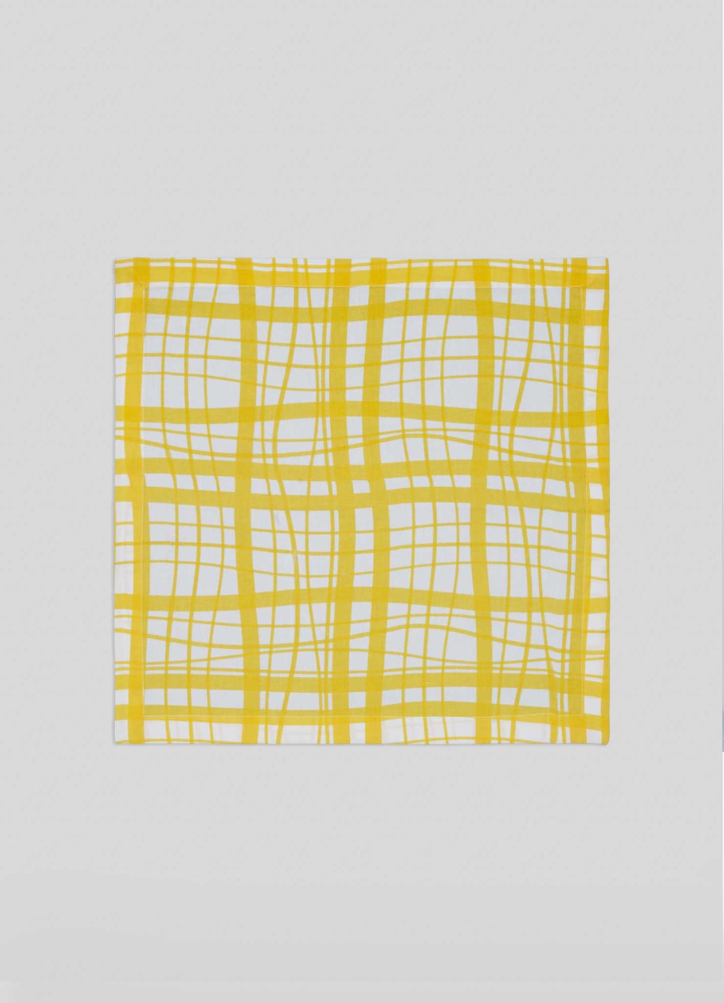 The Viya Madras Check Yellow Napkins (Set of 4) are square, white cloth napkins with yellow Madras-style irregular plaid checks, shown flat on a light gray background.
