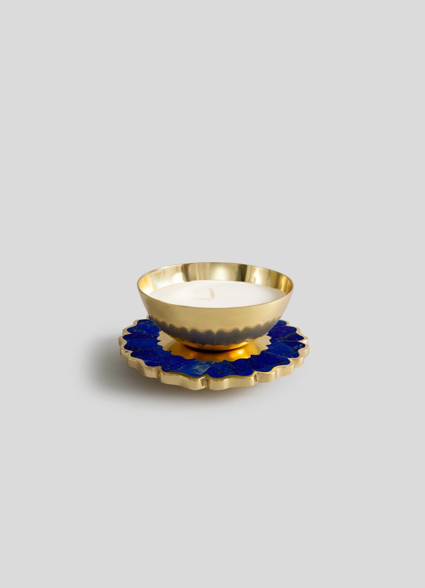 The Mystical Marigold Blue Scented Candle Diya Small - Set of 2 by Viya features gold-colored, scalloped-edge bowls on matching blue and gold trays inspired by Indian metalwork, set against a plain light gray background.