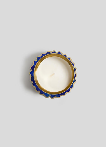 The Mystical Marigold Blue Scented Candle Diya Small - Set of 2 by Viya features white candles with centered wicks in round, gold-trimmed blue holders with scalloped edges, inspired by traditional Indian metalwork.