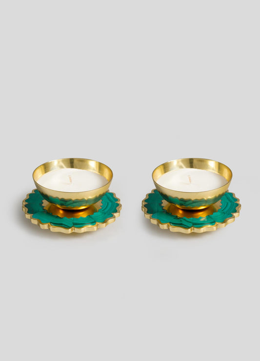 The Viya Mystical Marigold Green Scented Candle Diya Small Set of 2 features gold tealight holders with white candles on green and gold floral bases, blending ancient metalwork inspiration with a modern heirloom style.