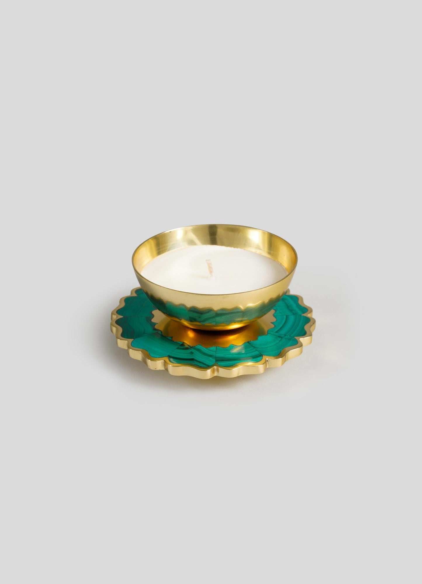 The Viya Mystical Marigold Green Scented Candle Diya Small (Set of 2) features white candles in round gold holders, displayed on decorative green and gold coasters against a plain light gray background.