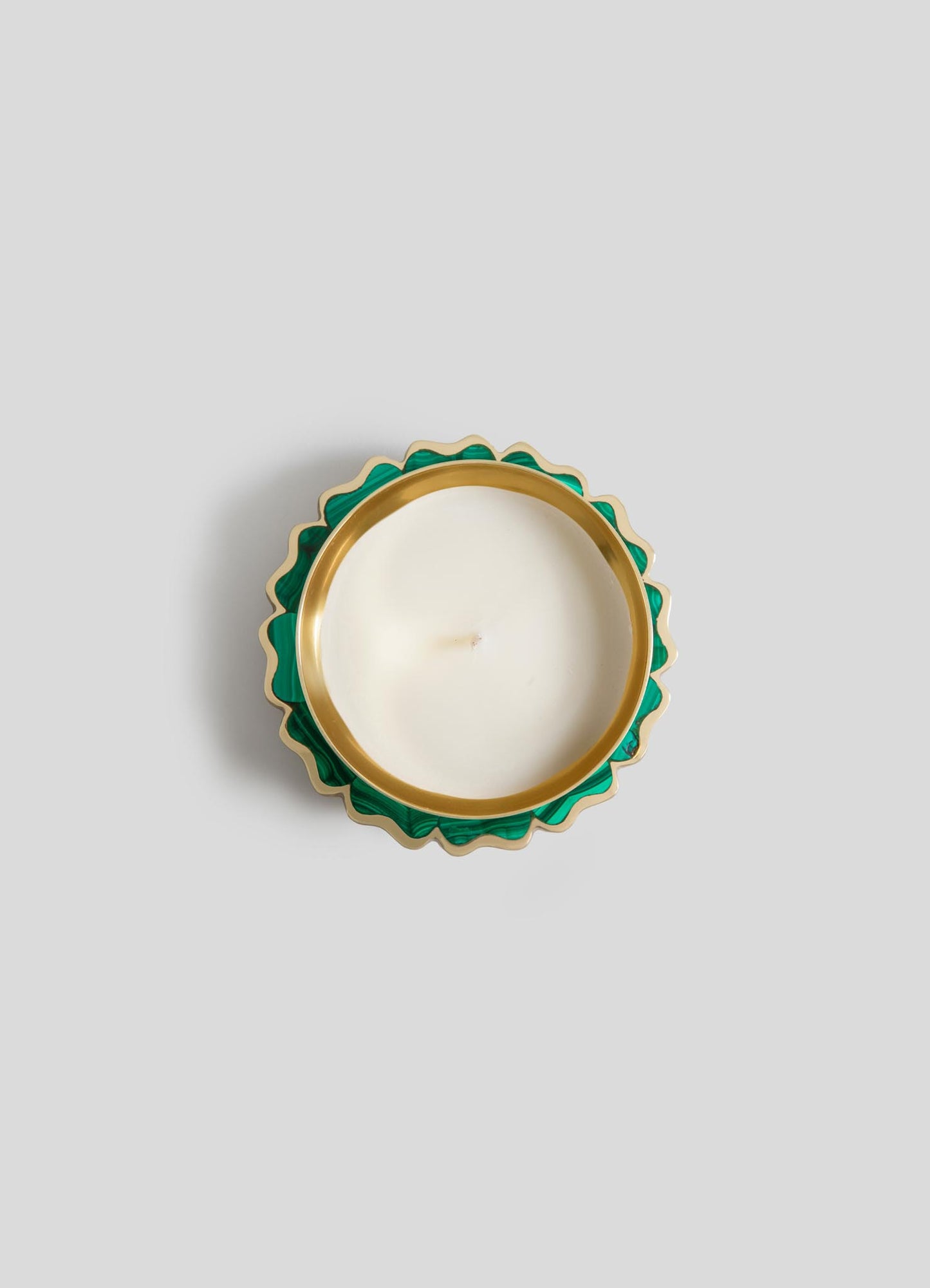 The Viya Mystical Marigold Green Scented Candle Diya Small (Set of 2) features round white candles in green and gold scalloped holders, crafted with ancient metalworking, shown from above on a light gray background.