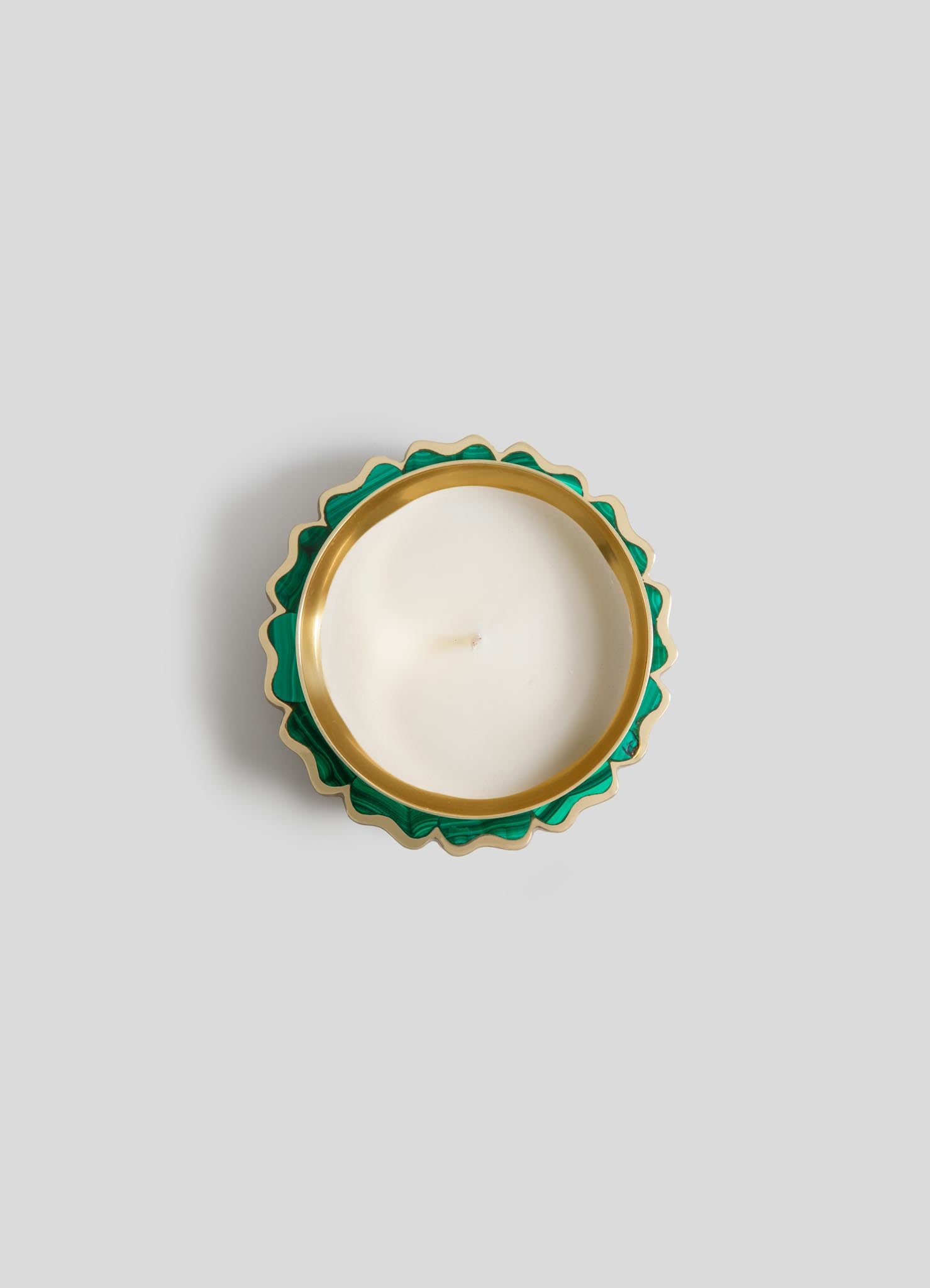 The Viya Mystical Marigold Green Scented Candle Diya Small (Set of 2) features round white candles in green and gold scalloped holders, crafted with ancient metalworking, shown from above on a light gray background.