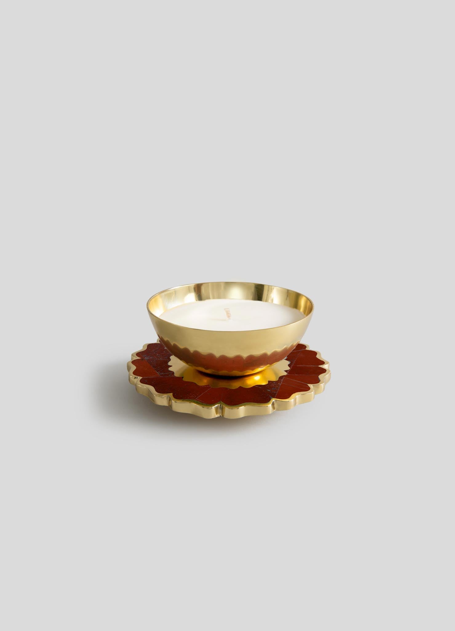 The Viya Mystical Marigold Red Scented Candle Diya Small (Set of 2) features gold, bowl-shaped candles with scalloped edges, placed on red and gold flower coasters, beautifully displayed against a light gray background.