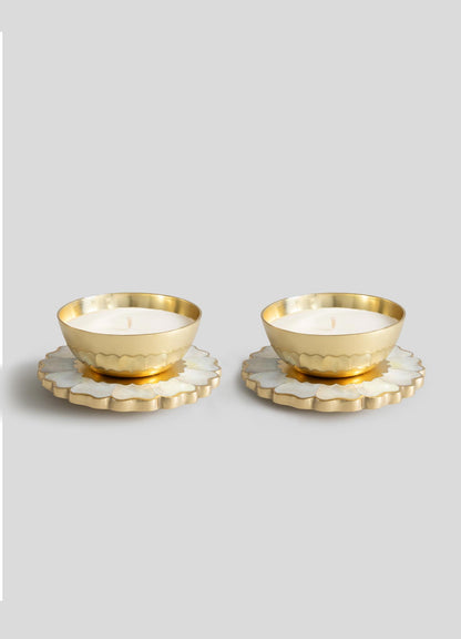 The Viya Mystical Marigold White Scented Candle Diya Small Set of 2 features gold-toned tealights in round holders on white and gold floral bases, showcasing modern heirloom charm inspired by ancient metalwork.