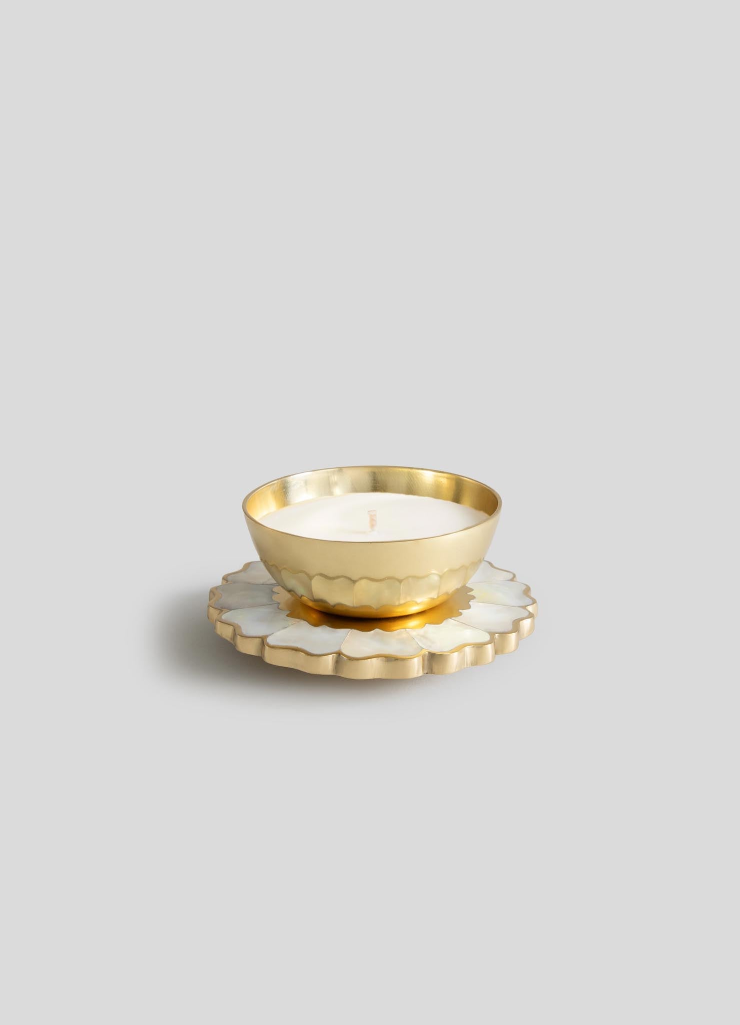 The Mystical Marigold White - Scented Candle Diya Small - Set of 2 by Viya features gold metal holders with white wax candles on decorative flower bases, highlighting Indian craftsmanship against a light gray backdrop.