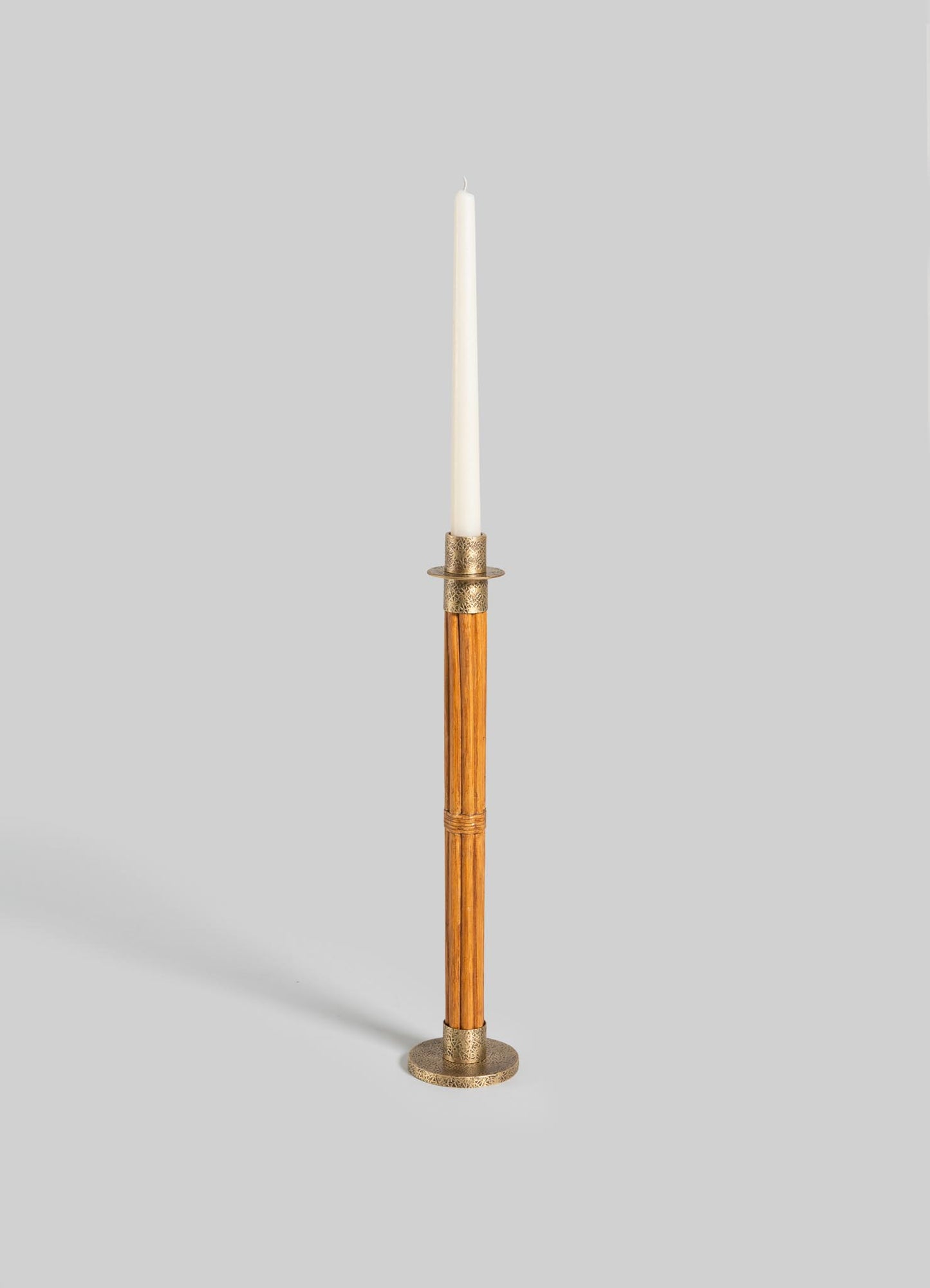 The VIYA Namsai Candle Holder Large features a tall, slender wooden body with brass accents and holds a white taper candle, displayed against a plain light gray background.