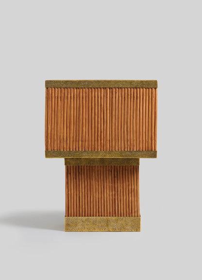 The Namsai Table Lamp Large by VIYA features parallel vertical cinnamon sticks with brass-trimmed top and bottom edges, displayed against a plain light gray background.