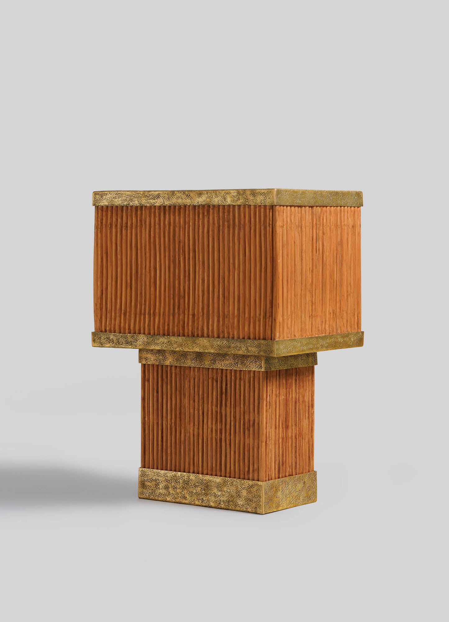 The VIYA Namsai Table Lamp Large is displayed against a plain light gray background, featuring a modern, rectangular silhouette with ribbed wooden panels, textured brass accents, and a unique staggered stacked design.