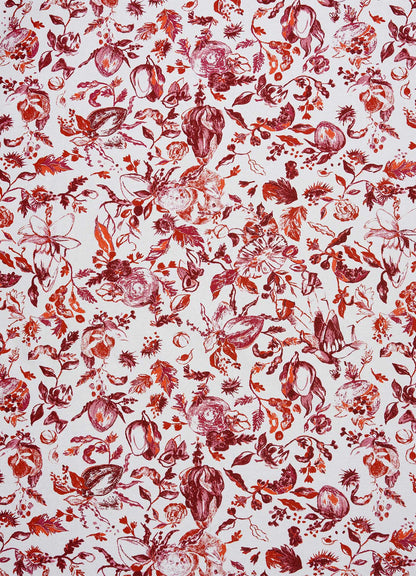 The Viya Orchard Red Table Cloth Large features a symmetrical, repeating design of vibrant red, orange, and pink floral and botanical patterns on white, inspired by Indian pomegranate motifs and orchard elements.