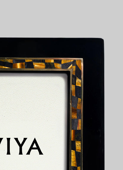 Close-up of the Plaza Photo Frame by VIYA, featuring a decorative checkered brown and black Art Deco-inspired inlay reminiscent of classic Bombay cinema halls, framing a textured white surface with partially visible black "VIYA" text.