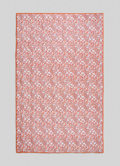 The Viya Paigah Orange & Blue Single Quilt is a rectangular fabric displaying intricate orange and blue Indo-Islamic abstract patterns with a solid orange border, shown against a light gray background.