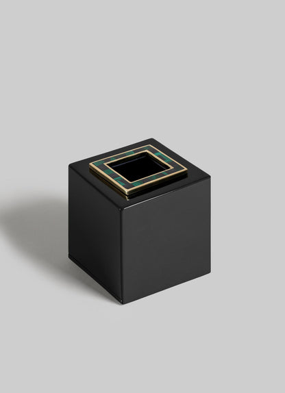 The VIYA Rivoli Cube Tissue Box is a glossy black square with a top opening, framed by gold and green Art Deco accents inspired by Bombay cinema halls, set against a light gray background.